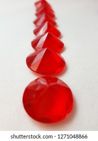 Red Plastic Craft Jewel Sequence Lined Up To Celebrate The Month Of Red Or The Month Of Valentines. Craft Supplies Make Nice Photos. 