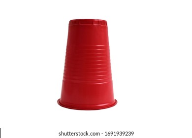 Red Plastic Cup Stands Upside Down On A White Background