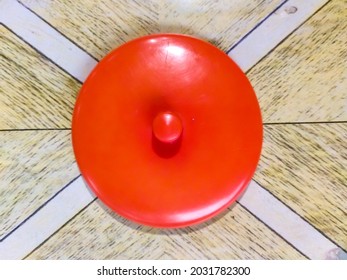 Red Plastic Glass Lid On The Wooden Tabel.