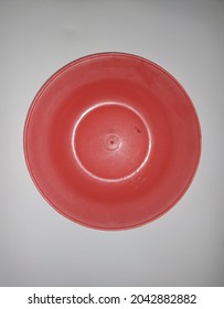 A Red Plastic Plate, On A Plain White Background.