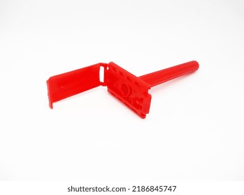 A Red Plastic Razor, On A White Background