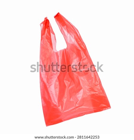 Red plastic shopping bag with handles.Empty red t-shirt style plastic bag.Lightweight red crinkled plastic grocery bag.Retail carryout bag,Red singlet bag,Handle plastic bag,Bulk shopping bags,
