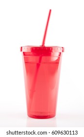 Red Plastic Tumbler Glass With Lid And Straw On A White Surface. Travel Cup Isolated On White.