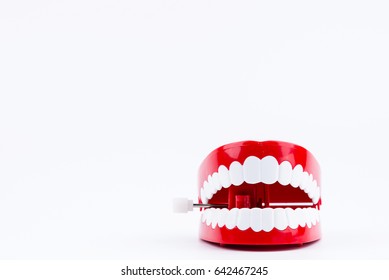 Red Plastic Wind Up Chattering Teeth isolated on White Background