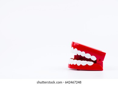 Red Plastic Wind Up Chattering Teeth Isolated On White Background