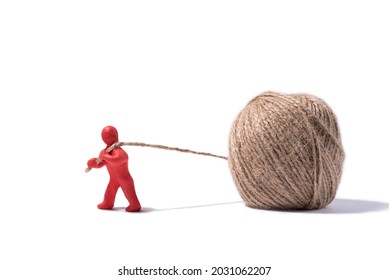A red plasticine man pulls a thread out of the ball