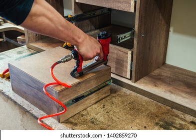 Red Pneumatic Stapler In A Furniture Workshop