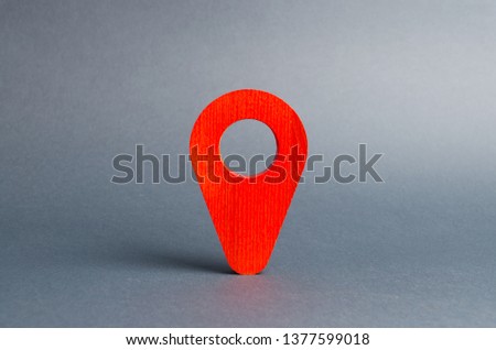 Red pointer location on a gray background. Concept of navigation and venue. Tourism and travel. Spying on the citizens.. Orientation around the city, the location of events and events.