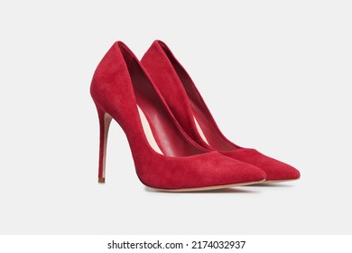 Red pointy toe women's shoes with high heels isolated on white background. Female classic stiletto heels in suede leather. Mock up, template