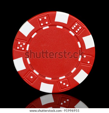 red poker chip over black background