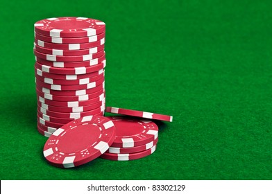 Red Poker Chips On A Green Table Background