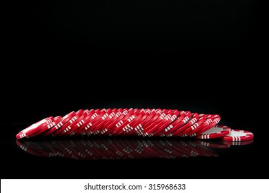 Red poker chips in a row over black background