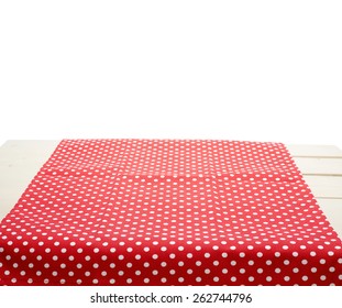 Red polka dot tablecloth or towel over the surface of a wooden table, composition isolated against the white background - Powered by Shutterstock