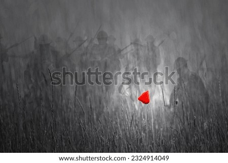 Red poppy on black and white background with faded soldiers charging out of the gloom.