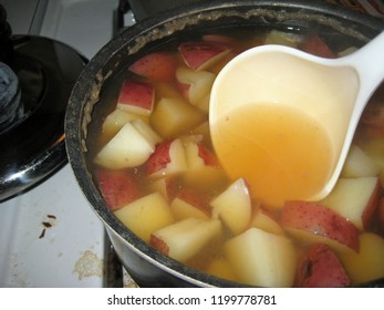 Red Potato Pieces Simmering In A Pot Of Chicken Stock Until Fork Tender And Mashed Into Smashed Potatoes