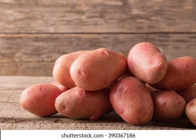 Red Potatoes On Wooden Background