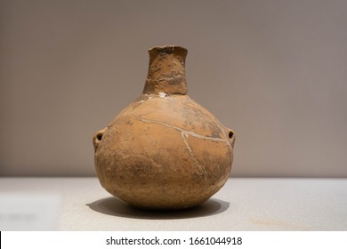 Red Pottery Ewer With Small Mouth, Double Handles, Long Neck And Swelling Belly. Ancient China, Early Or Middle Neolithic. Unearthed From Wuan, Hebei Province.