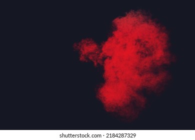 Red Powder Explosion Cloud On Black Background.