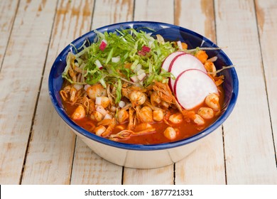Red pozole soup on a white wooden background - Shutterstock ID 1877721331