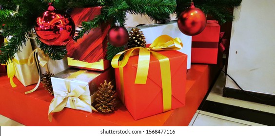 The Red present gift boxes under the Christmas tree in the New Year holiday Festival