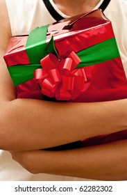 Red present in woman's hands.