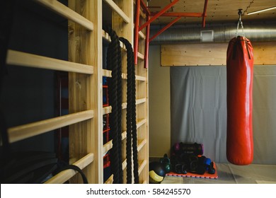 Red Punching Bag And Sports Equipment For Training In Modern Boxing Gym. Beautiful Toned Sport Background