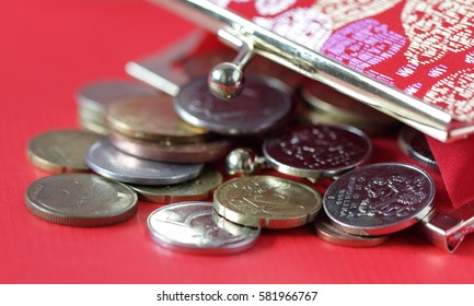 Red purse with different coins