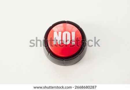 Red push button with bold white letters spelling NO placed on a clean white surface. A symbolic object for rejection, denial, refusal, or humorous feedback in various contexts.