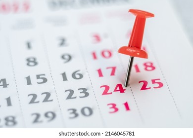 Red push pin on calendar 24th day of the month, mark the Event day with a Pin. Pin on calendar day twenty four, date number 24. Twenty-fourth day of the month is marked with a red thumbtack