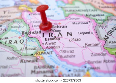 Red Push Pin Pointing on Iran The Political World Map Close-Up View Stock Photograph