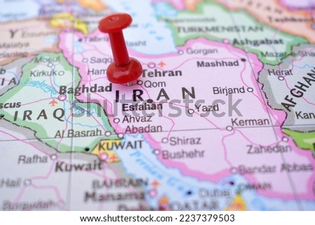 Red Push Pin Pointing on Iran The Political World Map Close-Up View Stock Photograph
