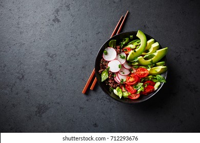Red Quinoa Buddha Bowl with Avocado, Radish, Spring Onion, Cherry Tomatoes , Chive and Fresh Basil. Home made food. Concept for a tasty and healthy vegetarian meal. Top view. Copy space.  - Shutterstock ID 712293676