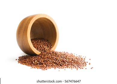 Red quinoa seeds in wooden bowl.