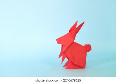 Red rabbit or bunny origami isolated in blue background. Chinese new year of the rabbit and easter celebration concept. - Shutterstock ID 2240679625