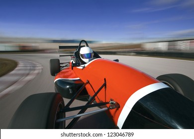 Red Racing Car Driving At High Speed In Circuit.Camera On Board