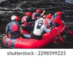 Red raft boat during whitewater rafting extreme water sports on water rapids, kayaking and canoeing on the river, water sports team with a big splash of water