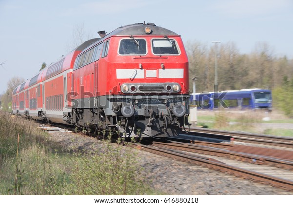 Red railcar pulls railroad\
wagon