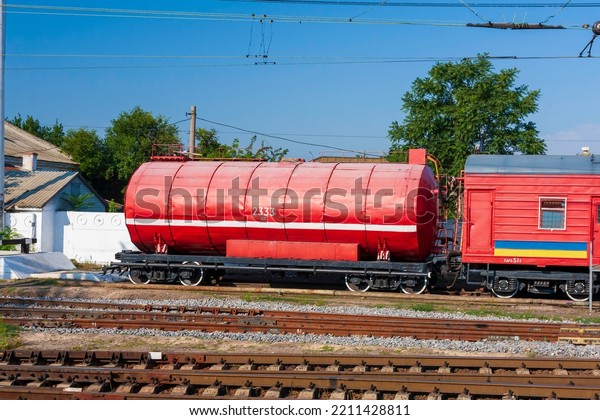 Red railway cistern for firefighting. Firefighting\
train, red tank with water. Railway fire safety equipment. Railway\
firefight train.