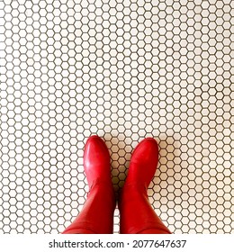 Red Rain Boots On White Penny Tile