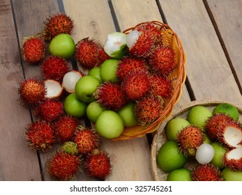Red rambutan Nephelium lappaceum on broun board. Fruit tropical tree of the family Sapindaceae , native to South - East Asia , cultivated in many countries in the region
