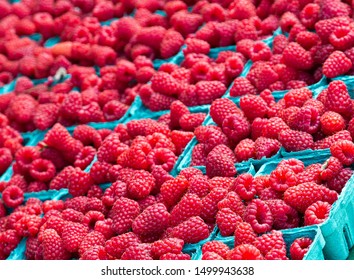 Red Rasberries In Blue Cartons In Fruit Market