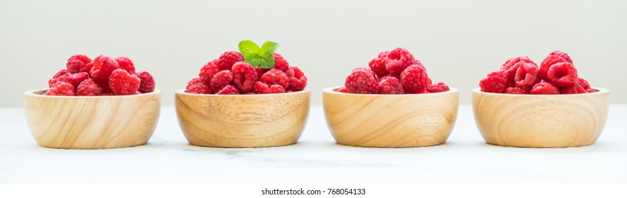 Red Rasberries Fruit In Wood Bowl On Table