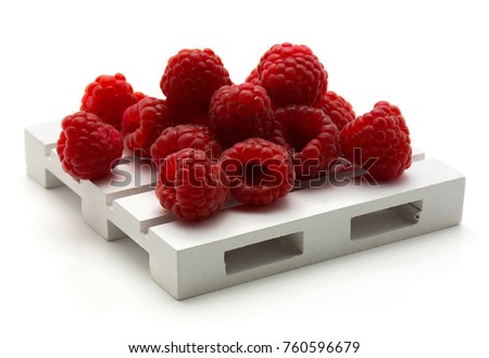 Red raspberries on pallet isolated on white background
