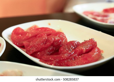 Red Raw Beef On White Dish On Tungsten Light