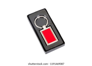 Red Rectangle Chrome Metal Key Chain In Black Paper Box Isolated On White Background.