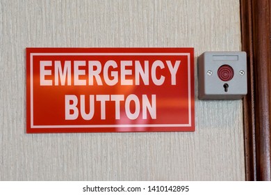 red rectangle emergency button sign placed next to a red button encased in metal housing.  - Shutterstock ID 1410142895