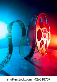 Red reel of film on a dark background 