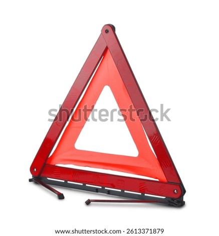Red reflective traffic warning triangle isolated on white