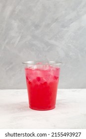 Red Refreshing Iced Cocktail In Disposable Plastic Cup. Summer Fruit And Berry Drink. Take Away, Street Food. Boba Drink Or Bubble Tea.