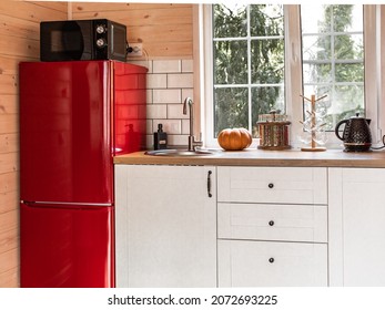 Red Refrigerator. White Kitchen Interior In A Country House. Black Microwave Oven. Black Teapot. French Windows. Kitchen Utensils.